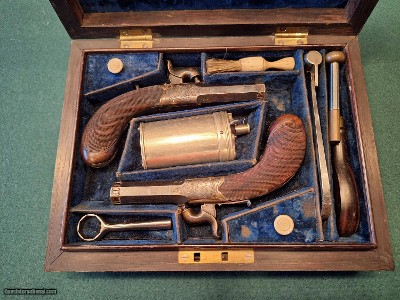 CASED PAIR OF SCREW BARREL, FOLDING TRIGGER, PERCUSSION MUFF PISTOLS