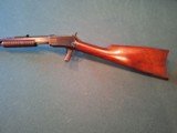 Winchester Model 1890 slid action take down rifle.