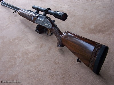 Josef Winkler of Austria O/U Sidelock Double Rifle Profusely Engraved with African animals & Includes two sets of barrels with Zeiss Scopes