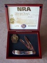 Case NRA Life Member Two blade folding knife with stage handles. Also included is NRA Life Member pin. Cherry wood case.
