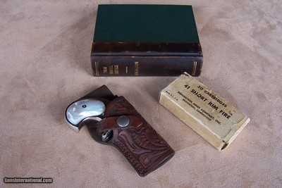 Remington Nickel Over & Under Nickel Derringer Model 95 with Pearl in special Hide-A-Way Book. Includes carved leather holster & box of cartridges