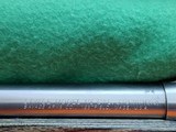SAVAGE116 in 270 win. STAINLESS STEEL FLUTED BARREL WITH A FACTORY ADJUSTABLE MUZZLE BRAKE, GREEN LAMINATED STOCK, VERY HARD TO FIND MODEL! - 4 of 17
