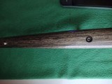 SAVAGE116 in 270 win. STAINLESS STEEL FLUTED BARREL WITH A FACTORY ADJUSTABLE MUZZLE BRAKE, GREEN LAMINATED STOCK, VERY HARD TO FIND MODEL! - 17 of 17