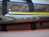 SAVAGE116 in 270 win. STAINLESS STEEL FLUTED BARREL WITH A FACTORY ADJUSTABLE MUZZLE BRAKE, GREEN LAMINATED STOCK, VERY HARD TO FIND MODEL! - 3 of 17
