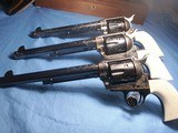Colt
Set of Three 3rd Generation Single Action Army Revolvers A,B, C Engraved all with Checkered Ivory Grips 1977 - 2 of 15