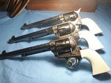 Colt
Set of Three 3rd Generation Single Action Army Revolvers A,B, C Engraved all with Checkered Ivory Grips 1977 - 1 of 15