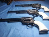 Colt
Set of Three 3rd Generation Single Action Army Revolvers A,B, C Engraved all with Checkered Ivory Grips 1977 - 15 of 15