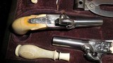 CASED PAIR OF MAGNIFICENT BELGIAN MUFF PISTOLS
36 CAL IVORY STOCKED
WITH ACESSORIES. VG COND - 2 of 5