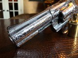 Colt Python .357 Magnum - Master Engraver Robert Valade - 4” - Nickel -
Deep Western Scroll Engraving - Like New - 22 of 25
