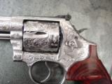 Smith & Wesson 686-6,fully engraved by Flannery,polished stainless,custom Rosewood grips,4