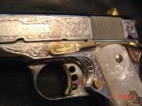 Colt Government Series 80,38 Super,Master engraved by S,Leis,refinished bright nickel with 24K gold accents,custom grips,2 mags,a work of art-awesome
- 13 of 15