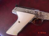 Colt Woodsman Match Target,master engraved by Brian Mears,nickel with 24K accents,real ivory grips,1957,22LR,6",awesome work of art.60 years old
- 3 of 15