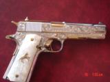 Colt 1911, 45,master engraved by Santiago Leis,refinished in bright nickel & 24K gold accents,Pearlite grips,case,manual etc. never fired,awesome gun
- 6 of 15