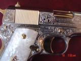 Colt 1911, 45,master engraved by Santiago Leis,refinished in bright nickel & 24K gold accents,Pearlite grips,case,manual etc. never fired,awesome gun
- 4 of 15