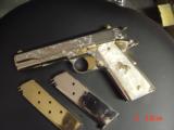 Colt 1911, 45,master engraved by Santiago Leis,refinished in bright nickel & 24K gold accents,Pearlite grips,case,manual etc. never fired,awesome gun
- 15 of 15