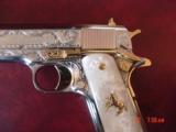Colt 1911, 45,master engraved by Santiago Leis,refinished in bright nickel & 24K gold accents,Pearlite grips,case,manual etc. never fired,awesome gun
- 7 of 15