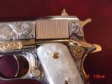 Colt 1911, 45,master engraved by Santiago Leis,refinished in bright nickel & 24K gold accents,Pearlite grips,case,manual etc. never fired,awesome gun
- 8 of 15