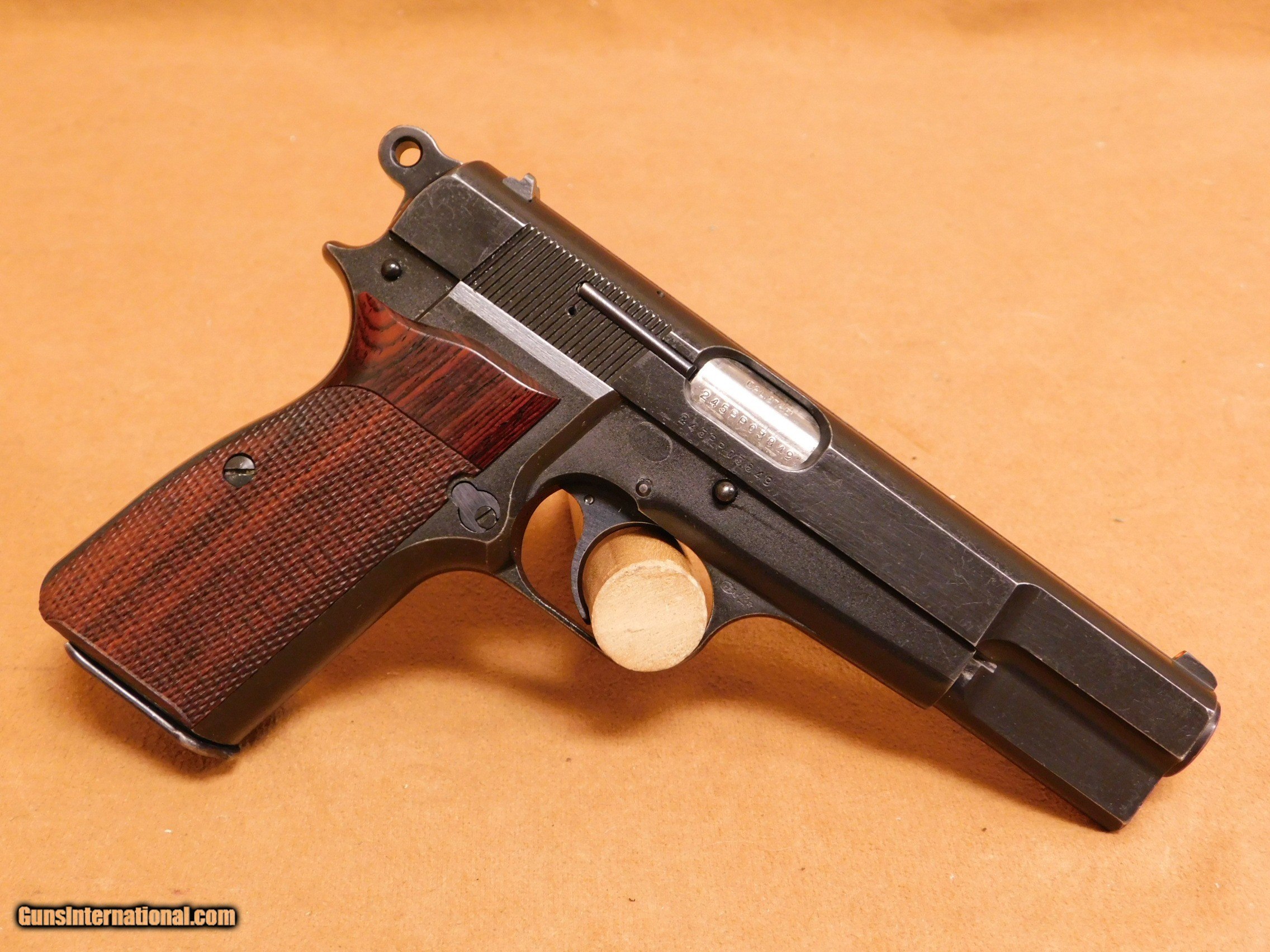 https://images.gunsinternational.com/listings_sub/acc_64542/gi_101473804/Browning-FNH-Hi-Power-Mark-II-and-40-with-Hogue-Wood-Gripsand-41-Mk-2_101473804_64542_4D75E5F24A2D24DE.JPG