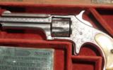CASED RARE MINT FACTORY ENGRAVED REMINGTON SMOOT’S PATENT 1ST MODEL .30 RF CAL. REVOLVER CA. 1875.
- 2 of 11