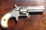 CASED RARE MINT FACTORY ENGRAVED REMINGTON SMOOT’S PATENT 1ST MODEL .30 RF CAL. REVOLVER CA. 1875.
- 6 of 11