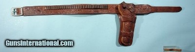 COLORADO SADDLERY CO. FLORAL CARVED 7 ½” SINGLE ACTION HOLSTER & MATCHING .45 CAL. WAIST SIZE 38 CARTRIDGE BELT CA. 1960’S.