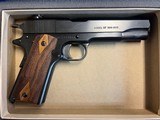 As new Colt 1911 100th Anniversary Tier III .45 with box and glass case - 1 of 6