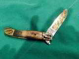 Vintage folding knife via release lever -profusely ornate blase and case
- 1 of 4
