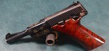 BROWNING
NOMAD .22 CAL. PISTOL WITH 4 1/2" BARREL - SCROLL ENGRAVING WITH GOLD WASH ACCENTING THE ENGRAVING. - 1 of 7