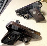 PAIR of COLT vest pocket 1908 HAMMERLESS = 1919 & 1929 Vintage = .25 acp Calibre = blue = Different Grip style - 1 of 9