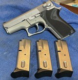 MODEL 6906 = 9MM = STAINLESS = FACTORY CHECKERED GRIPS W/ LOGO = THREE (3) 12 ROUND MAGAZINES - 3 of 12