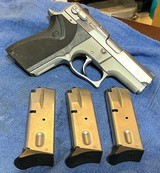 MODEL 6906 = 9MM = STAINLESS = FACTORY CHECKERED GRIPS W/ LOGO = THREE (3) 12 ROUND MAGAZINES - 1 of 12