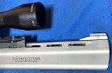 RAGING 22 HORNET = 10 INCH RIBBED BARREL = STAINLESS = PREMIRE SCOPE = CUSHIONED GRIPS = TAURUS HAND CANNON - 4 of 10