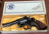 S & W = PRE MODEL 10 , m&p = BLUE = FOUR (4) INCH =98% CONDITION = Grey / Gray / Silver box w/ S&W paper wrap == - Image 1 of 13