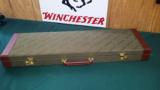4661
Winchester Shotgun case, green with brown leather sides. - 1 of 3
