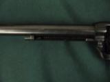 6315 Colt Single Action Buntline Scout 22 Long Rifle 9 1/2 inch barrel correct box and oil paper, black composite grips, no drag line, 99% condition,
- 10 of 12