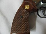 7584 Colt
PYTHON 357 mag 6 inch barrel red ramp front site, rug, white outline rear adjustable,walnut checkered grips with medallion, mfg 1985 s/ - 8 of 12