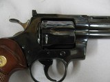 7584 Colt
PYTHON 357 mag 6 inch barrel red ramp front site, rug, white outline rear adjustable,walnut checkered grips with medallion, mfg 1985 s/ - 10 of 12