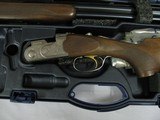 7700 Beretta Silver Pigeon I 20
gauge 28 inch barrel 99% condition, AS NEW IN CASE ,5 chokes, sk ic mod im ful wrench, booklets, coin silver engraved - 4 of 15