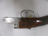 7809
Winchester 23 Golden Quail 410 ga 26 inch barrels mod/full straight grip, ejectors,solid
rib,quail and dog engraved on coin silver receiver, Wi - 11 of 14