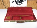 7816
Winchester green shotgun case with leather trim, red interior, with keys, 26