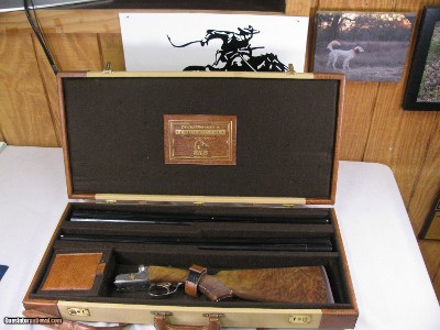 7997
SKB 385 Ducks Unlimited set, Only 200 were Made, 20/28 Ga, The stock is C-grade American walnut in high gloss finish with a semi-beavertail fore