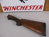 8107
Winchester Model 21 12 Gauge wood stock, woods length is 14 1/2”, with the leather pad the length is 15”, pistol grip, nice figured wood.
