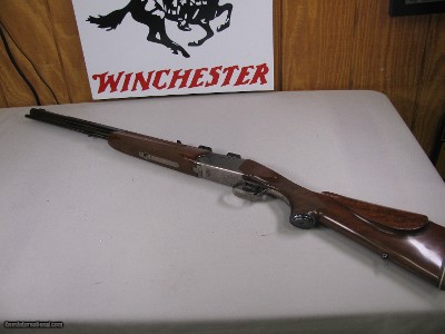 8123
Winchester Super grade 12 gauge over 222 Remington. Only 1000 ever produced, This is number 830. Has bases for scope, Cheak piece, Rose and scro