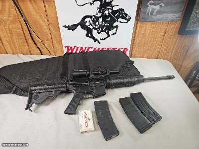 8882
DPMS A-15 223- NEW- Collapsible stock, Picatinny rail. 3
30 round magazines. In a canvas tactical soft case. One box of shells, Nikon M223- 2-4