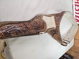 8884
Hand tooled leather holster, 38-40 “ waist, Lined with suede, will take a 10” Barrel. Darker brown leather. - 1 of 9