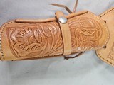 8885
Hand tooled leather Holster, 32 to 34 waist, made in Mexico, will take a 8 1/2 barrel. Light leather - 2 of 8