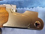 9065
Beretta 692, 12 gauge, 30” barrels, 6 chokes (2 Skeet, IC, M, IM, LM, CL) cleaning rod, 2 snap caps, Beretta ASE AAA fancy walnut, vent rib, but - 8 of 25
