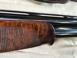9065
Beretta 692, 12 gauge, 30” barrels, 6 chokes (2 Skeet, IC, M, IM, LM, CL) cleaning rod, 2 snap caps, Beretta ASE AAA fancy walnut, vent rib, but - 24 of 25