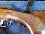 9065
Beretta 692, 12 gauge, 30” barrels, 6 chokes (2 Skeet, IC, M, IM, LM, CL) cleaning rod, 2 snap caps, Beretta ASE AAA fancy walnut, vent rib, but - 4 of 25