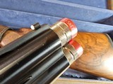 9065
Beretta 692, 12 gauge, 30” barrels, 6 chokes (2 Skeet, IC, M, IM, LM, CL) cleaning rod, 2 snap caps, Beretta ASE AAA fancy walnut, vent rib, but - 22 of 25